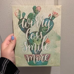 Cactus sign “worry less smile more”